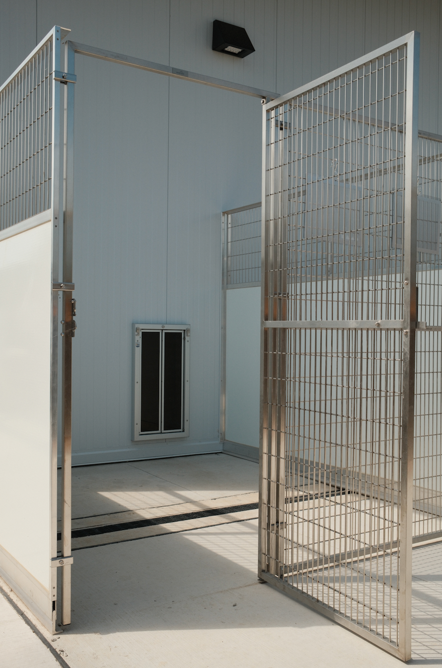 Outside of a villa patio with doggy door and outside door